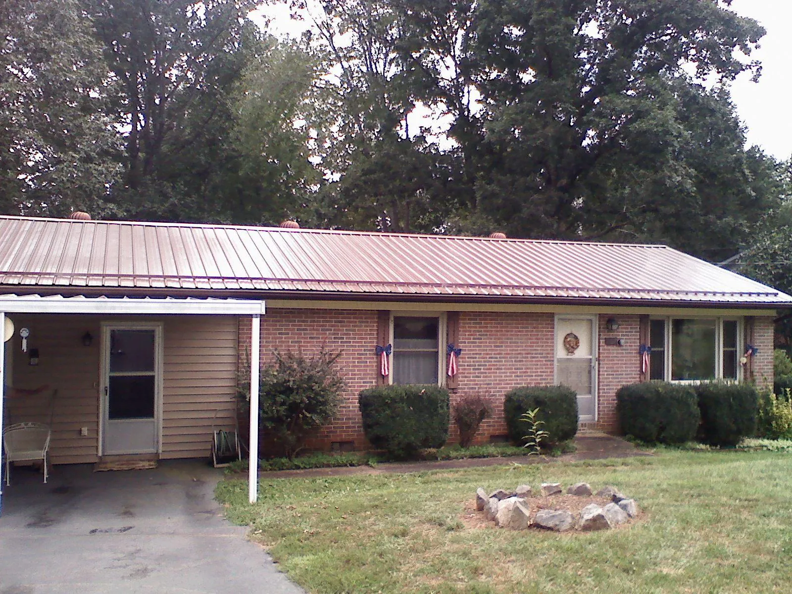Bronze metal roof and carport on a brick ranch home — Roof Repair work by our crew in South Richmond Hill